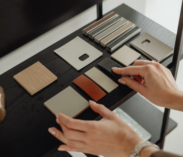 hands-tailor-choosing-fabric-from-catalog-making-bespoke-suit-1