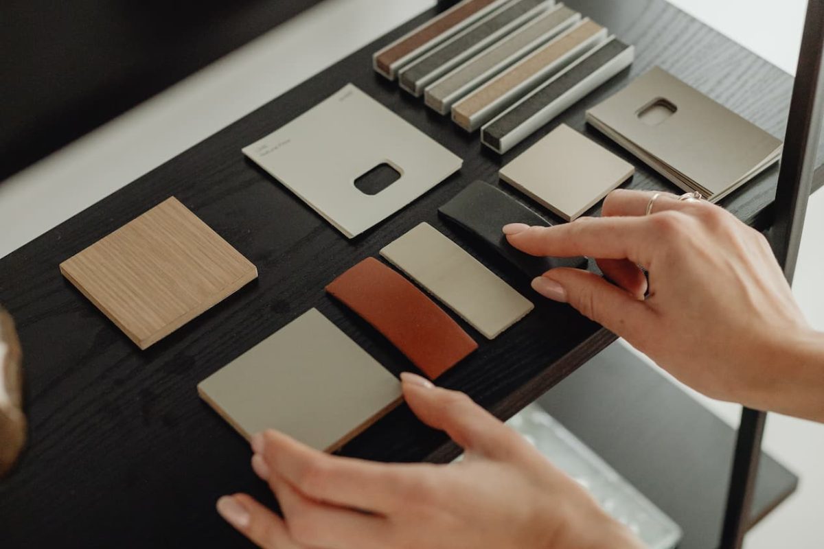 hands-tailor-choosing-fabric-from-catalog-making-bespoke-suit-1